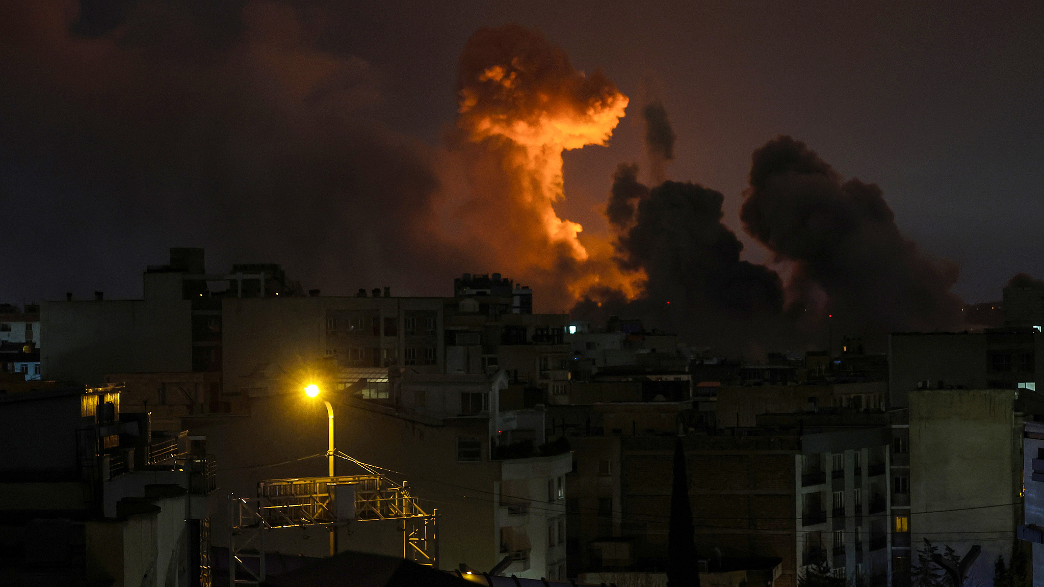 A large plume of smoke rises after explosions were reported in the city during the night in Tehran, Iran, March 28, 2026. /VCG