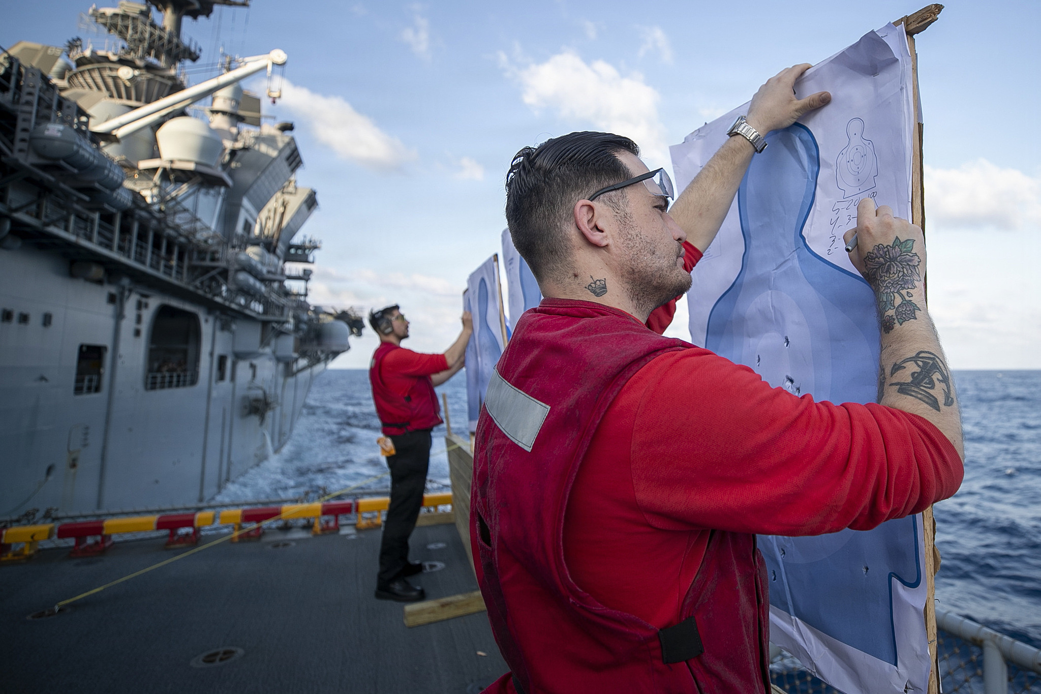 Master-at-Arms 2nd Class Logan Bonaguidi (R) grades a target during a live-fire exercise aboard America-class amphibious assault ship USS Tripoli (LHA 7), March 12, 2026. /VCG