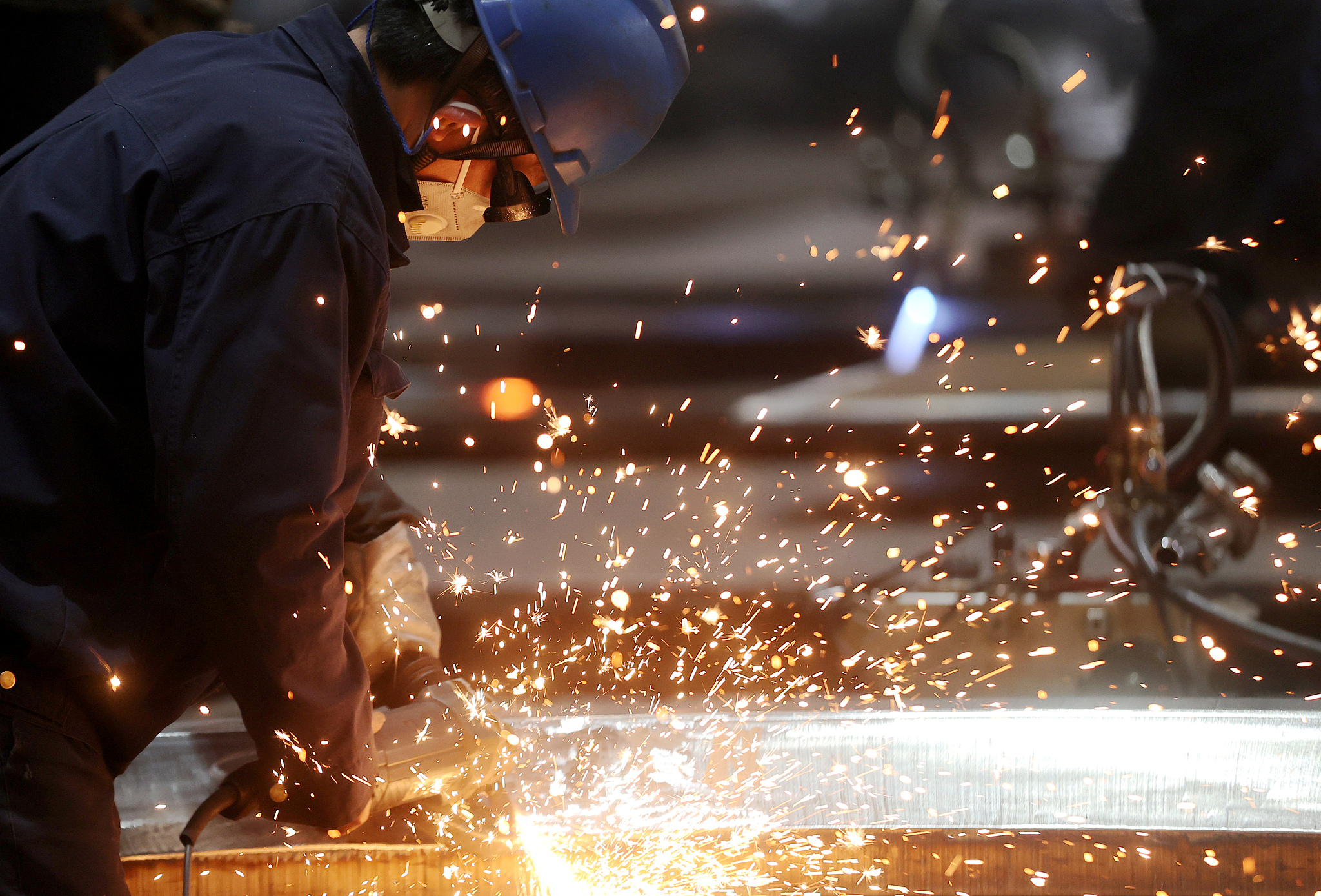 Workers carry out welding operations on metal structural components in Huzhou, Zhejiang Province, March 16, 2026. / VCG