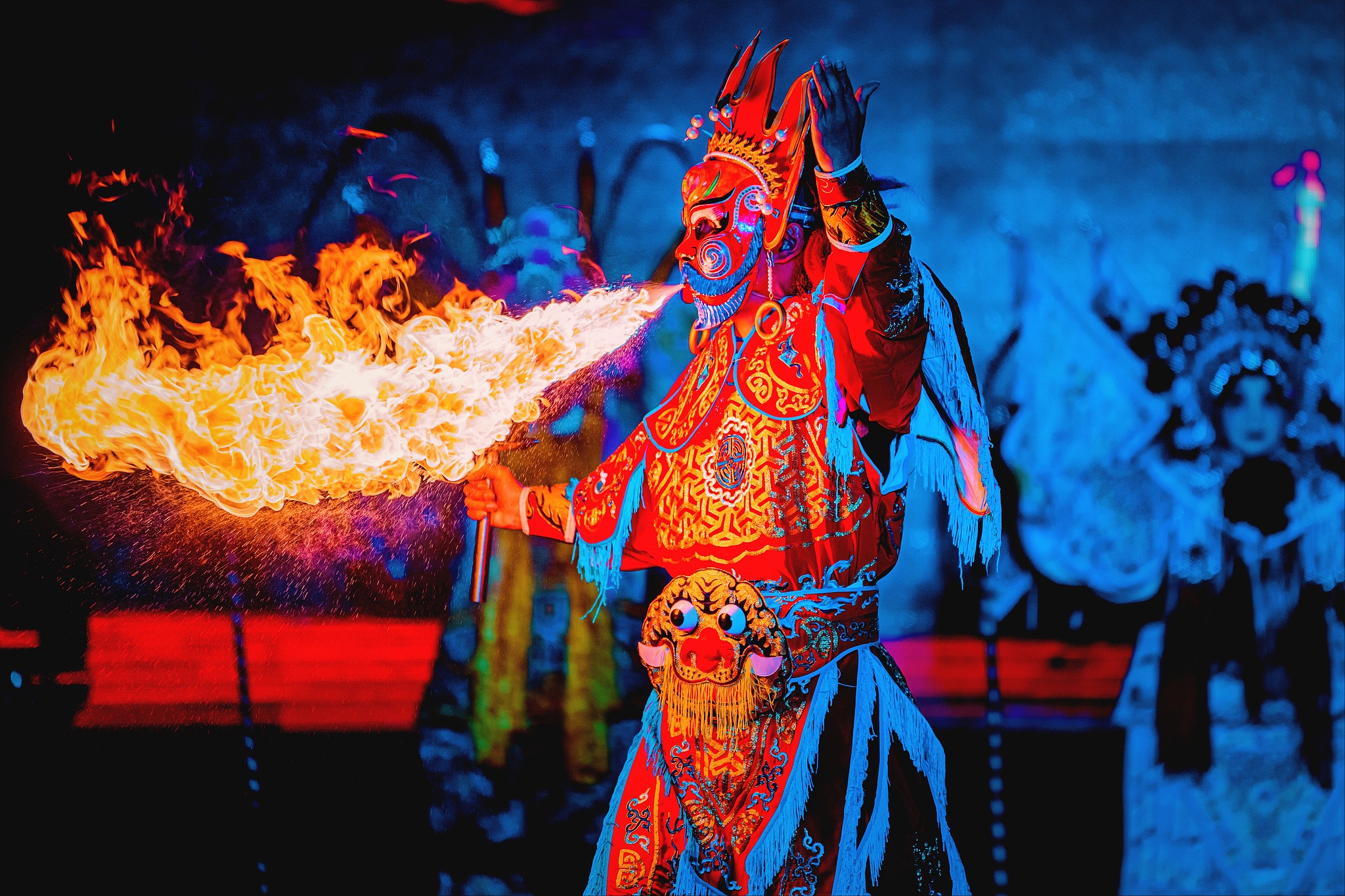 Sichuan Opera performer in Chengdu, China, breathes fire on stage (tu huo). /VCG