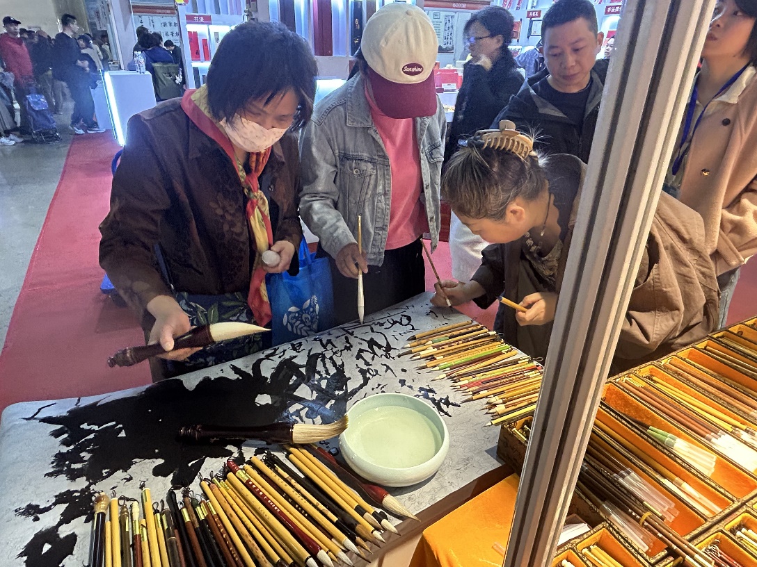 Calligraphy aficionados meticulously test an array of brushes, savoring each stroke's nuance before selecting their ideal instrument for artistic expression at the 56th National Four Treasures of the Study Art Expo in Beijing on March 30, 2026. /CGTN.