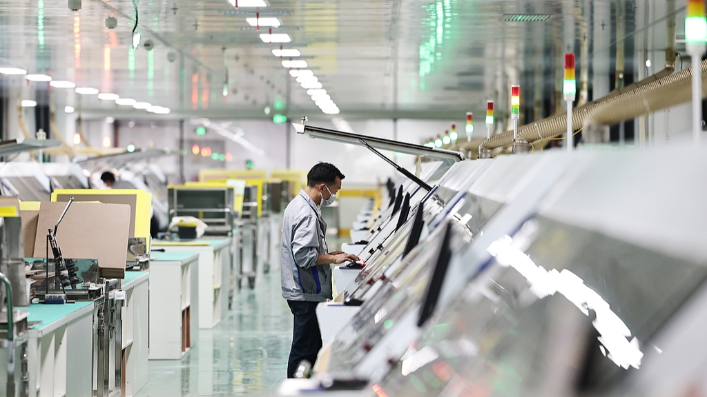 A worker checks an automated production line inside an upgraded and retrofitted workshop in Hubei Province, China, March 27, 2026. / VCG