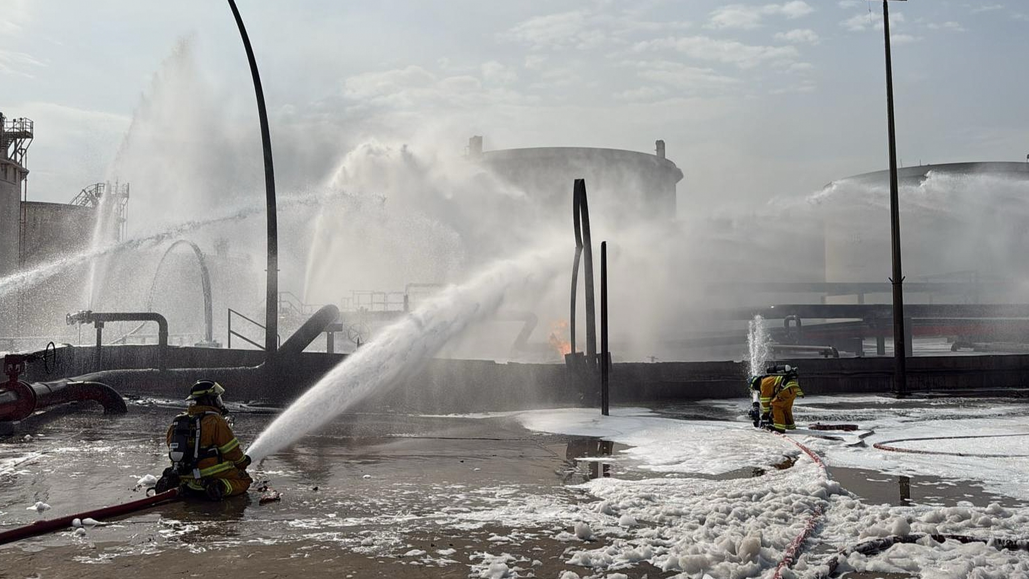 This image released by Bahrain's Interior Ministry shows firefighters extinguishing flames after a projectile struck an industrial area in Ma'ameer, Bahrain, March 9, 2026. /VCG
