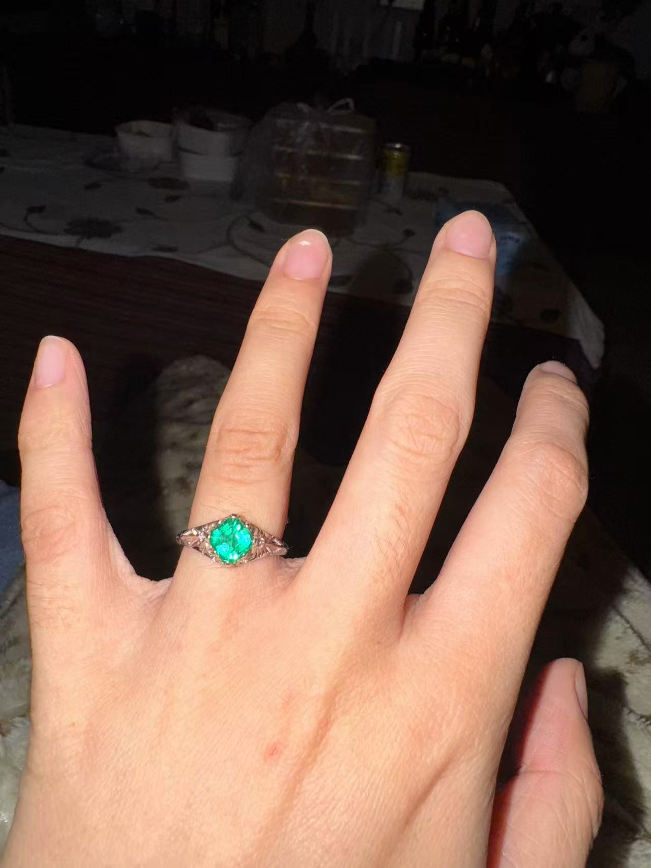 Jasmine's engagement ring is an emerald stone set in a white gold band. Ivan designed the ring especially for her. /Jasmine
Xu