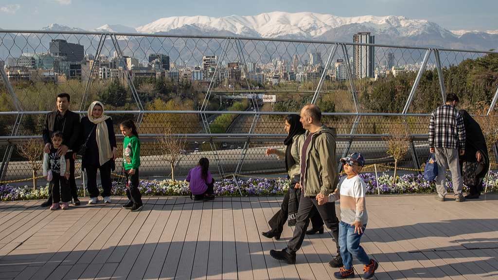 Amid US-Israeli attacks on Iran, people walk outside to celebrate 13th day of Nowruz in Tehran, Iran, April 2, 2026. /VCG