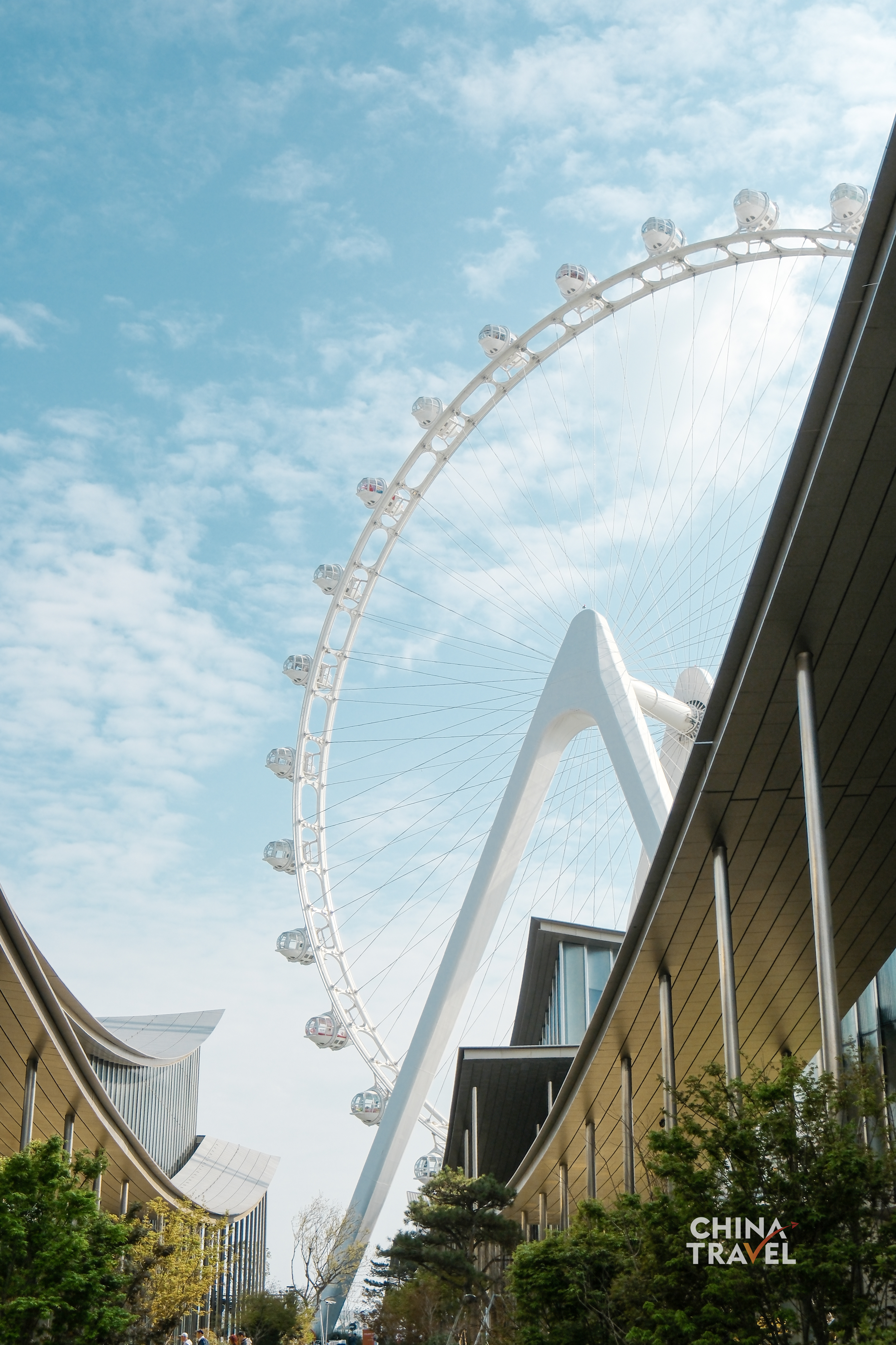 The Ferris wheel rises against the sky, its clean lines echoing a city constantly reaching upward. /CGTN