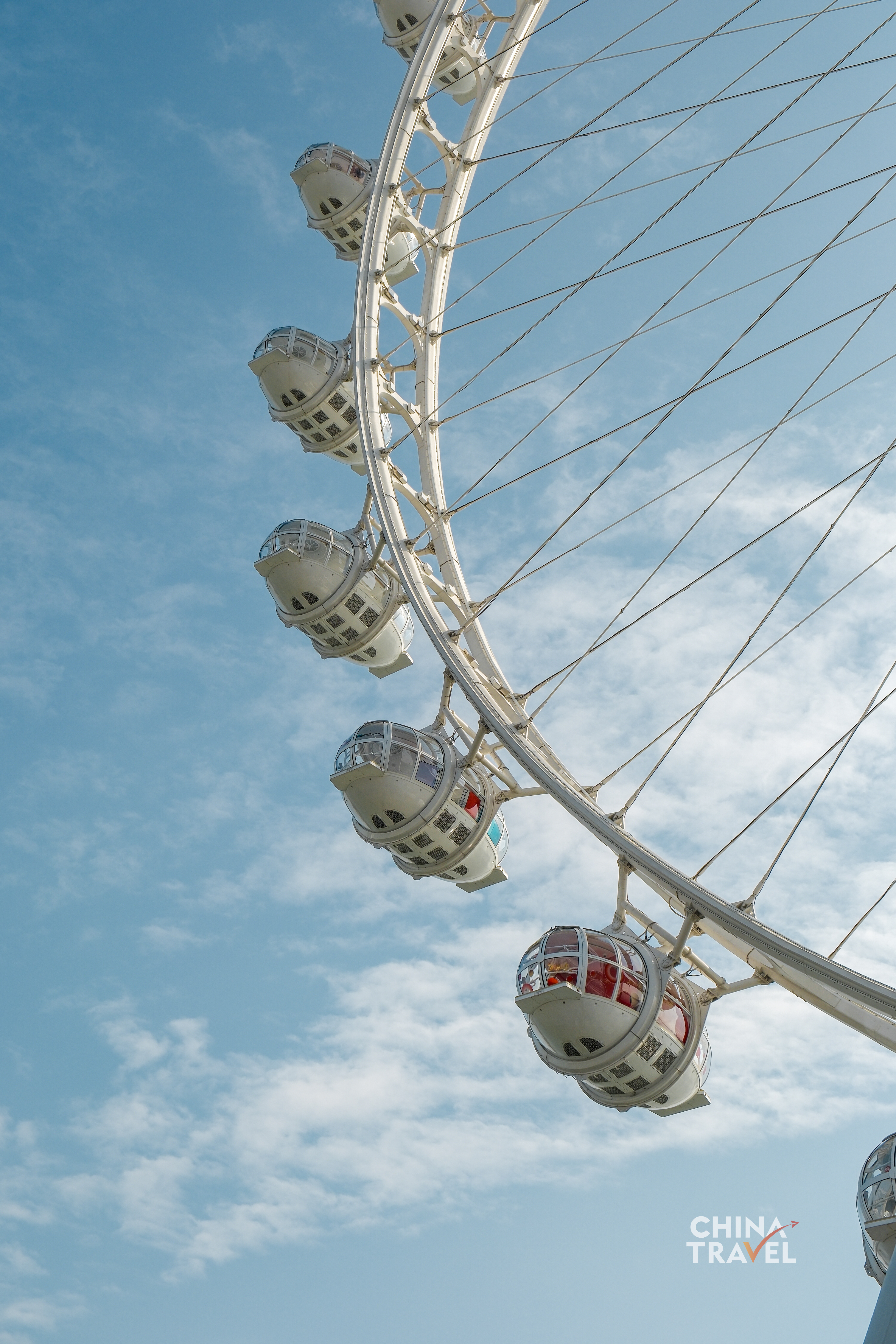 The Ferris wheel rises against the sky, its clean lines echoing a city constantly reaching upward. /CGTN