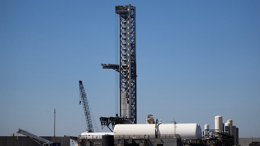 A Starship launch tower stands at the Starbase launch site at SpaceX