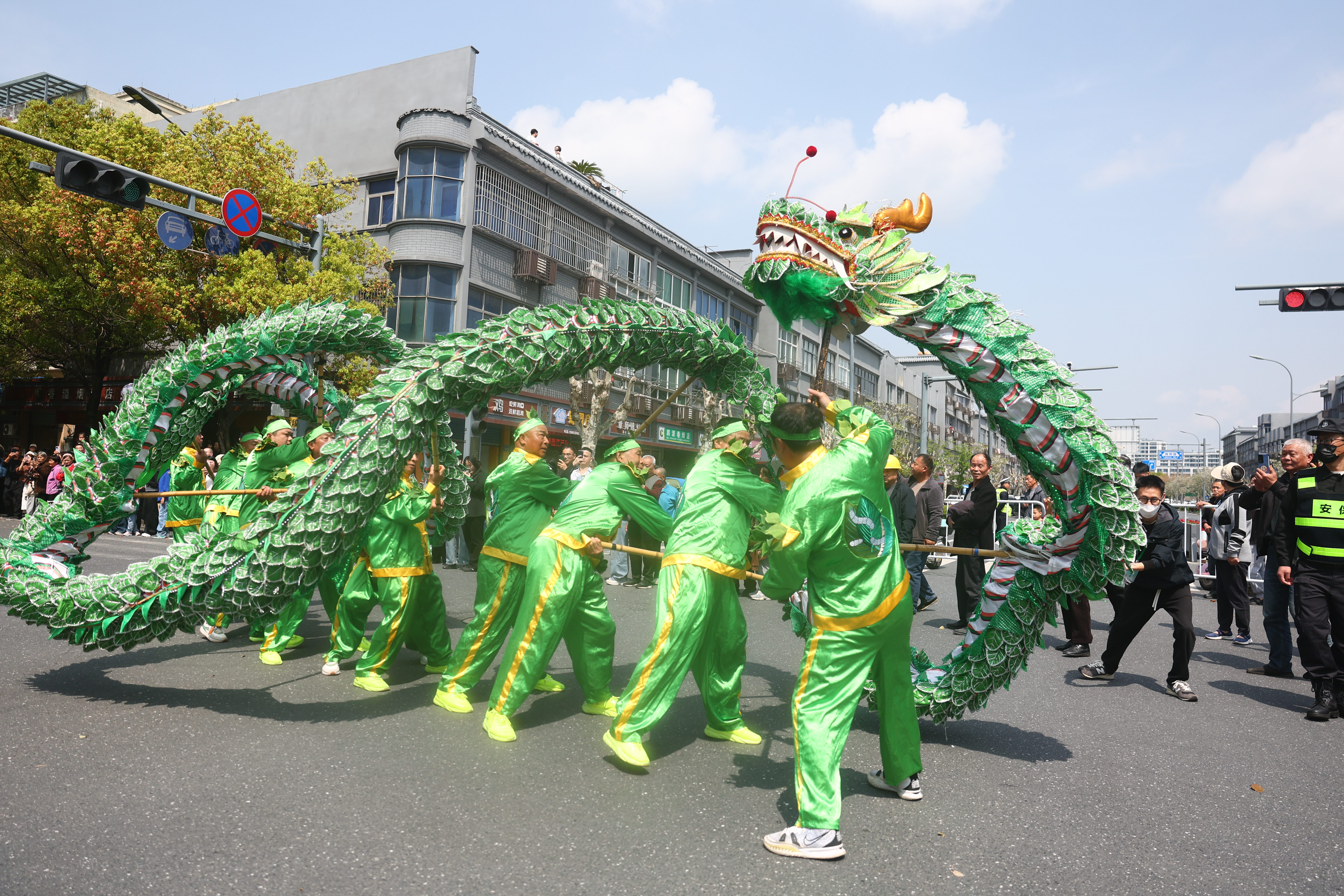 A mulberry leaf dragon dance performance attracts crowds of residents and visitors in Xinshi Ancient Town in Deqing County, Zhejiang Province on April 4, 2026. /CGTN