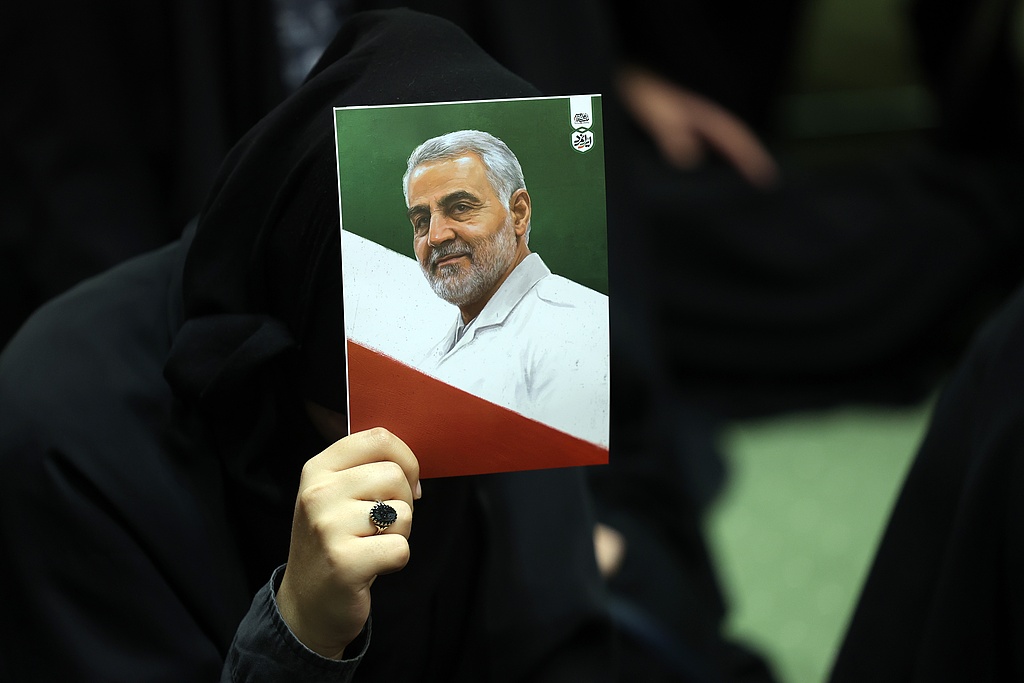 Iranians hold images of the late IRGC Quds Force commander Qassem Soleimani, in Tehran, Iran, on January 1, 2026. /VCG