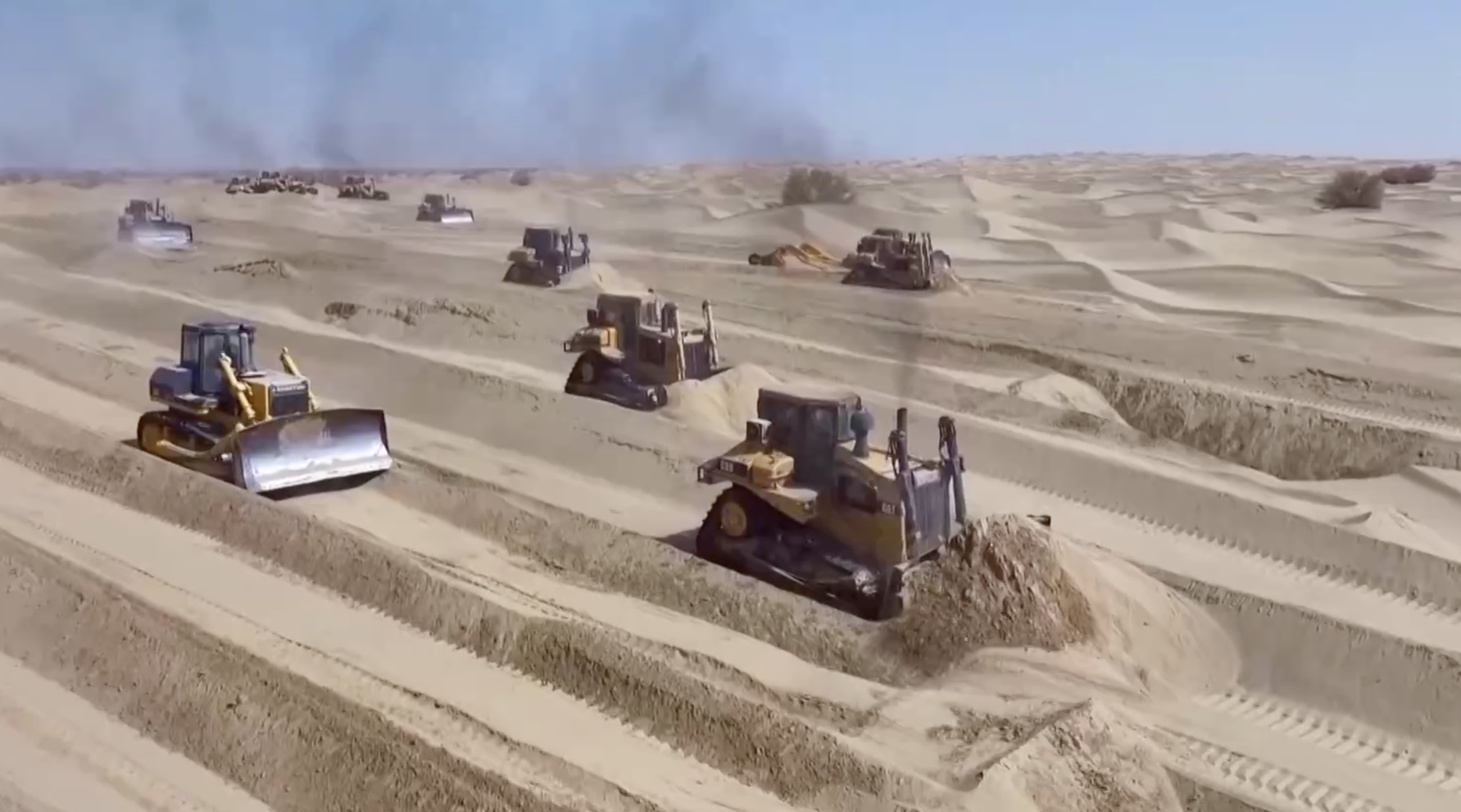 The bulldozers are leveling the dunes. /CMG