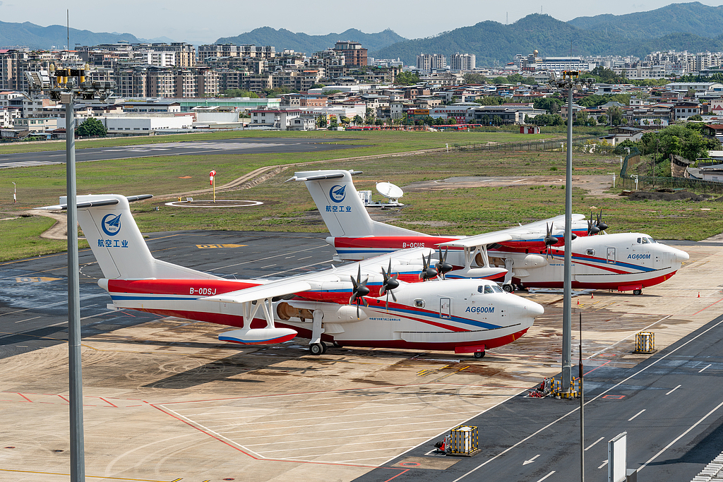 AG600M amphibious aircraft No. 1102 and No. 1103 are parked on the apron at Meizhou Meixian Airport during a low-altitude water-dropping training session in Meizhou, south China's Guangdong Province, April 4, 2026. /VCG