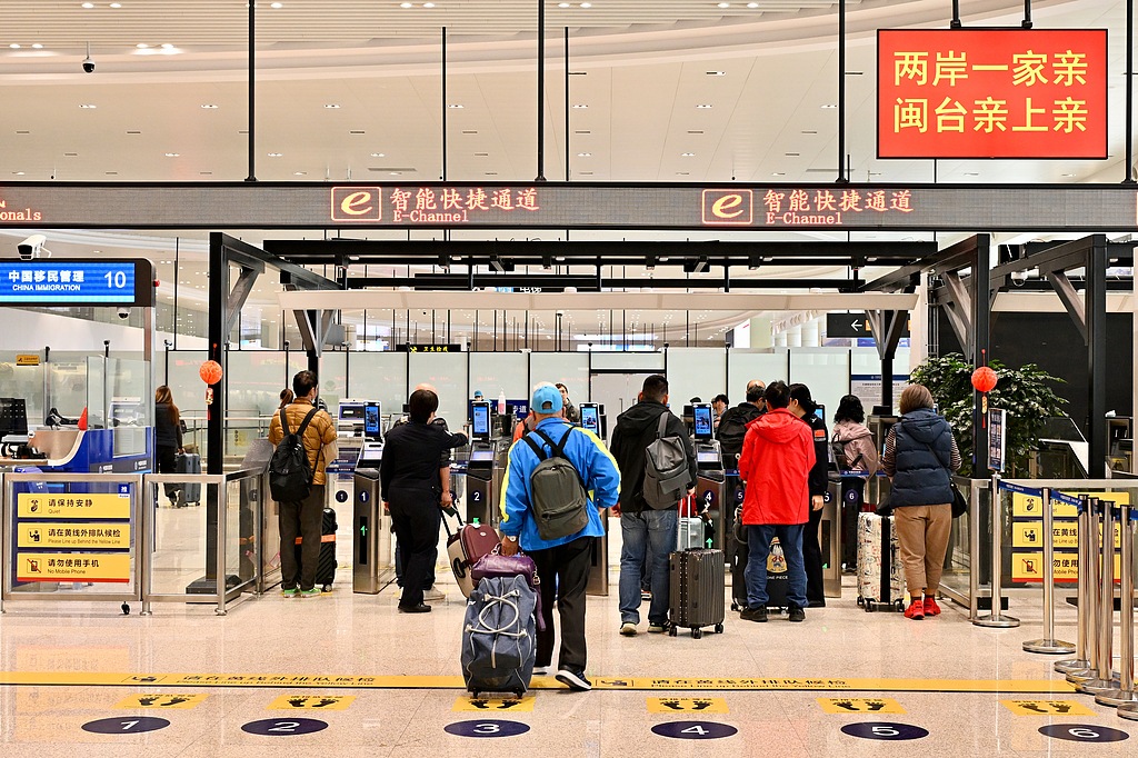 Taiwan compatriots pass through an intelligent fast-track clearance channel at the Wutong Passenger Terminal in Xiamen City, Fujian Province in southeastern China, December 9, 2025. /CFP