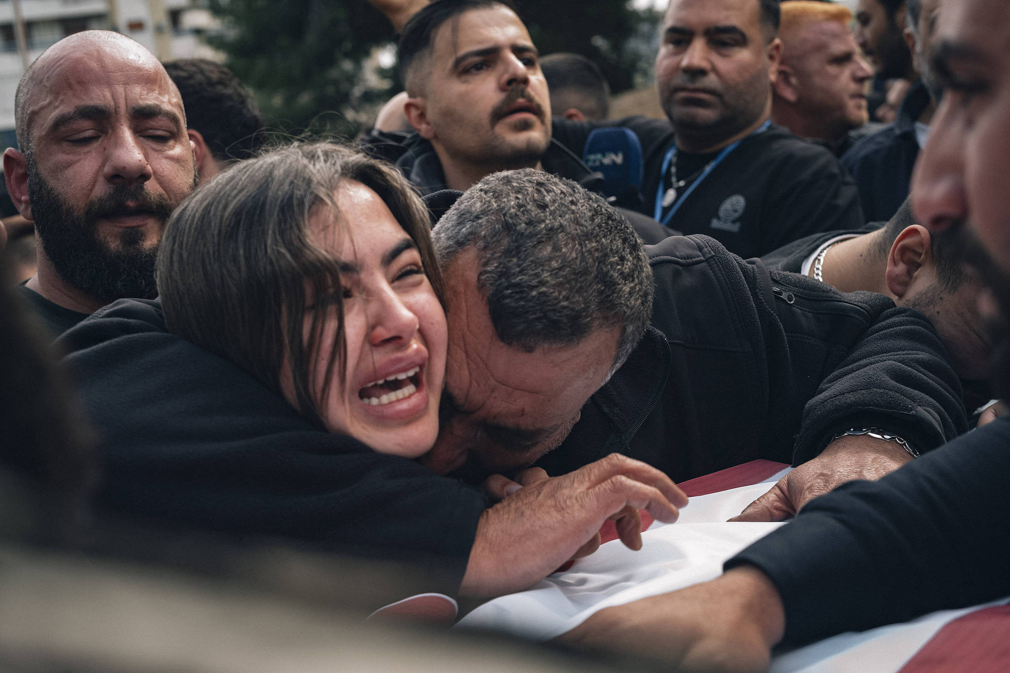 A man and a woman stand alongside the coffin of the woman's husband in Saida, Lebanon, April 11, 2026. /VCG