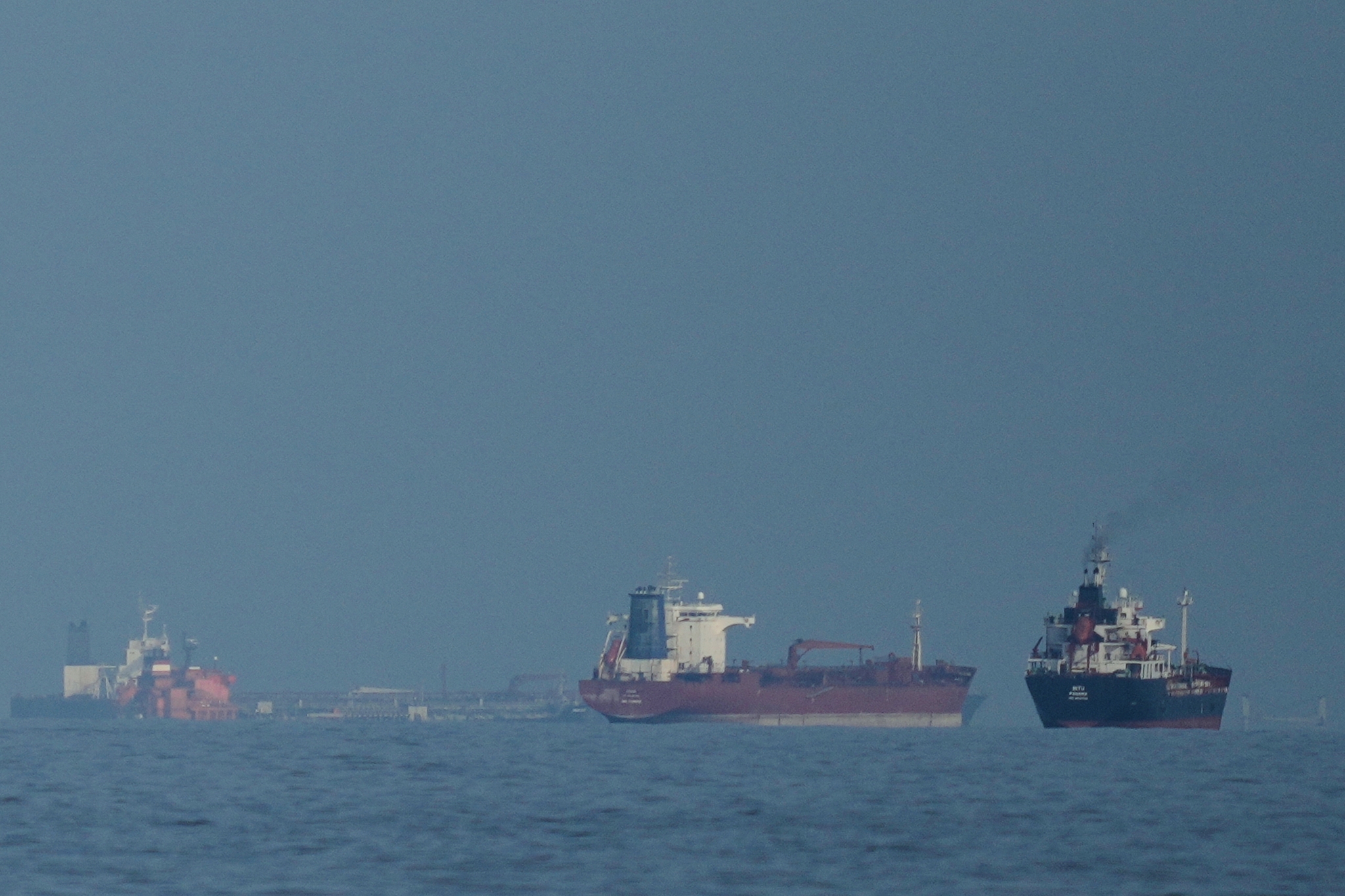 Oil tankers and cargo ships line up in the Strait of Hormuz as seen from Khor Fakkan, United Arab Emirates, March 11, 2026. /VCG