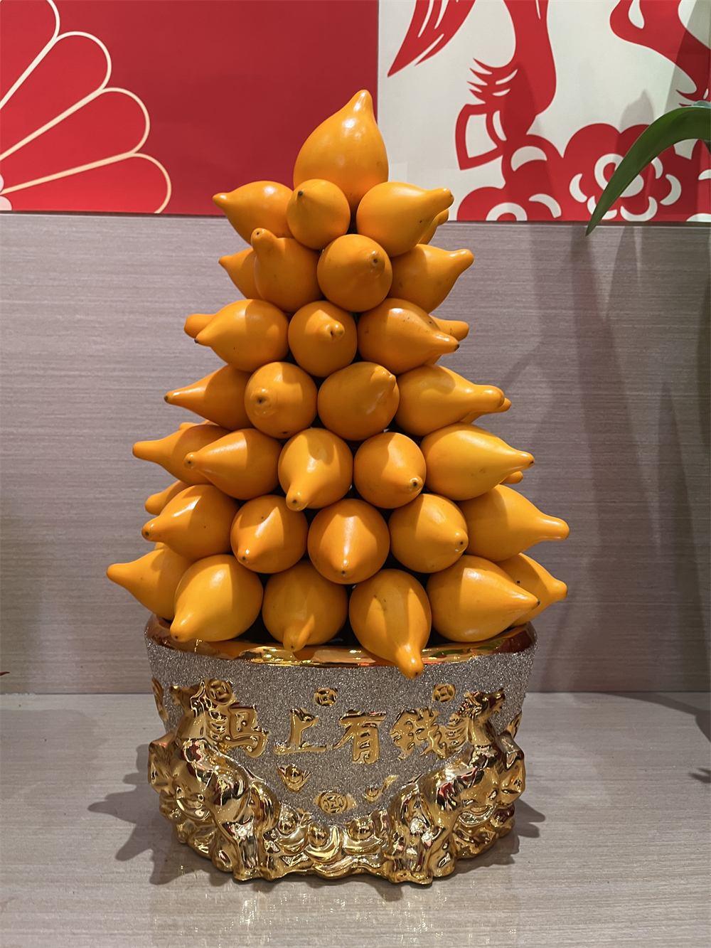 Golden eggplants are piled on a gold-silver pot to form a bonsai, standing for wealth and prosperity in Chinese tradition. /CGTN