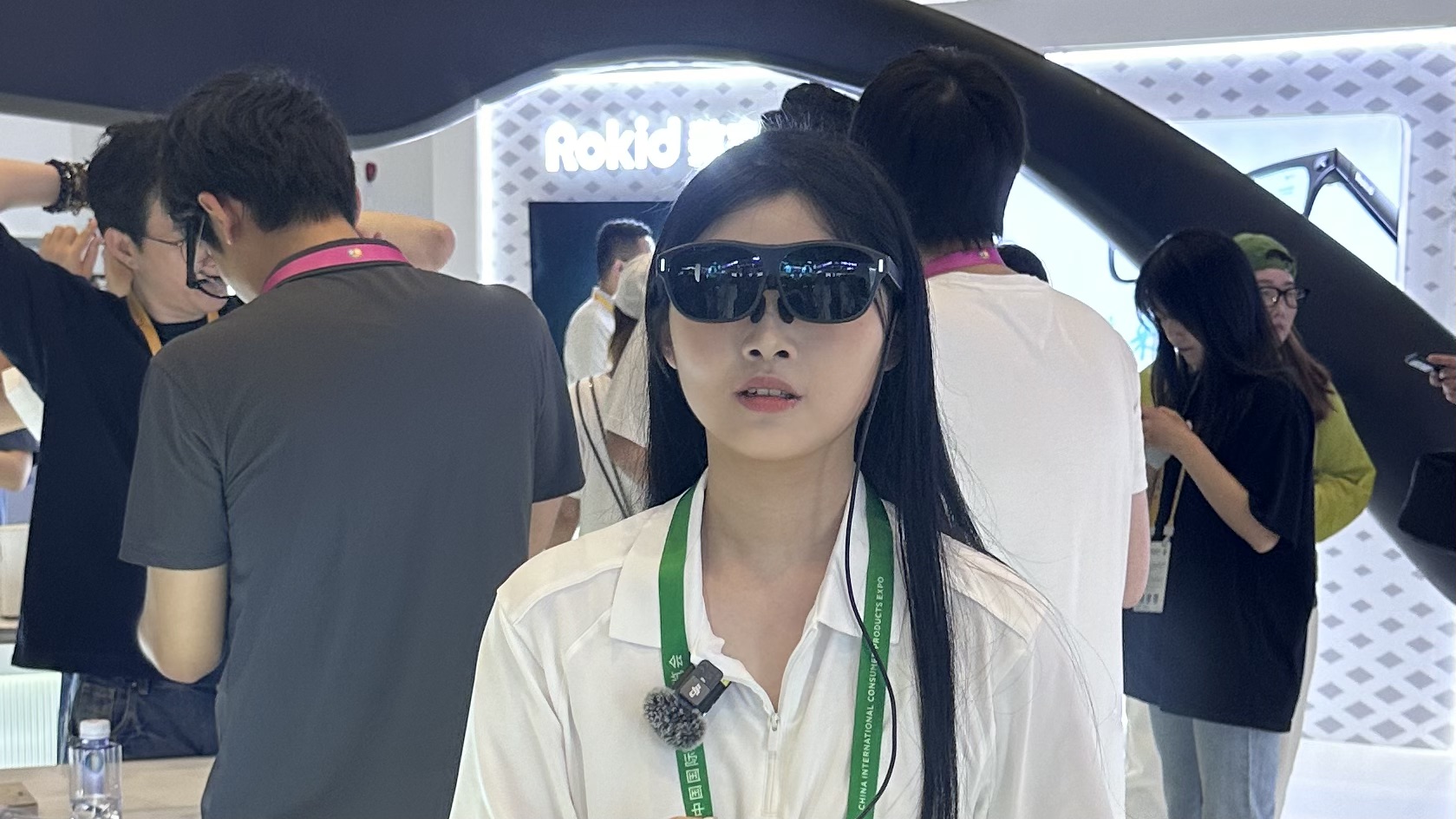 A staff member trying on artificial intelligence-enabled glasses at China International Consumer Products Expo, Hainan Province, China, April 13, 2026. /CGTN