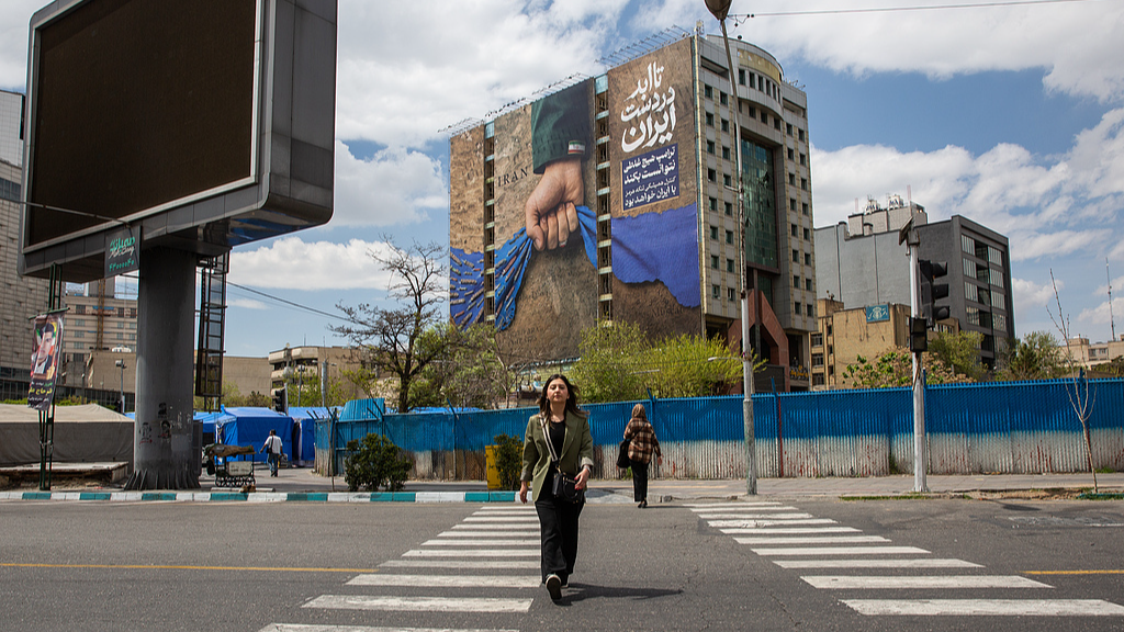 A mural on the side wall of a building is showing the Strait of Hormuz with a note saying 