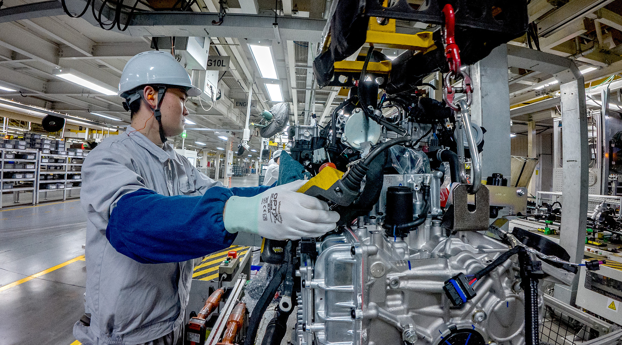 A worker operates a machine at a factory in Yichang, Hubei Province, China, March 2, 2026. /VCG