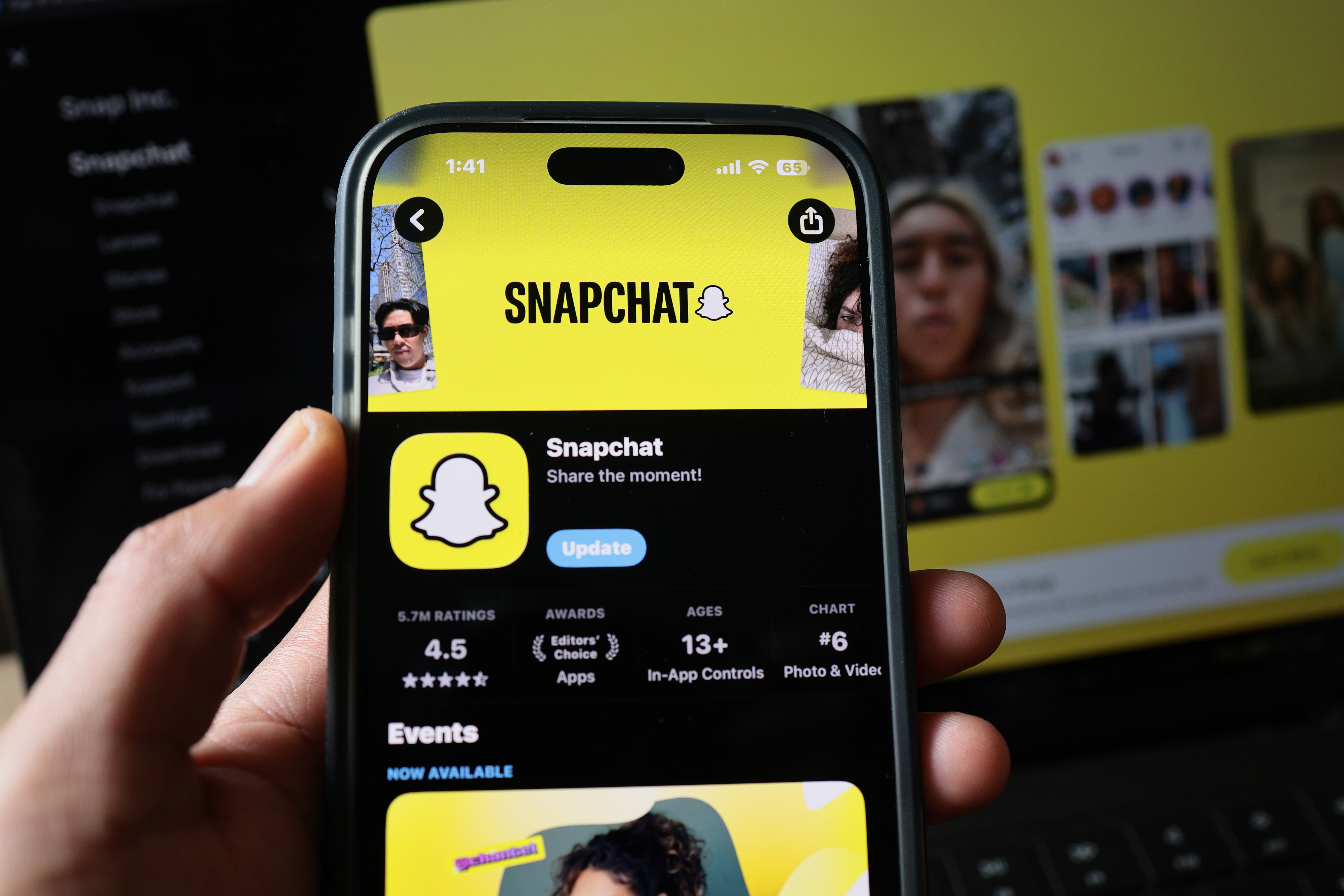 A photo illustration of a hand holding a phone showing the Snapchat app on its screen. Snap made an announcement that it plans to cut about 1,000 jobs, which includes 16 percent of its full-time staff, as the company seeks to lower costs and increase its reliance on artificial intelligence. /VCG