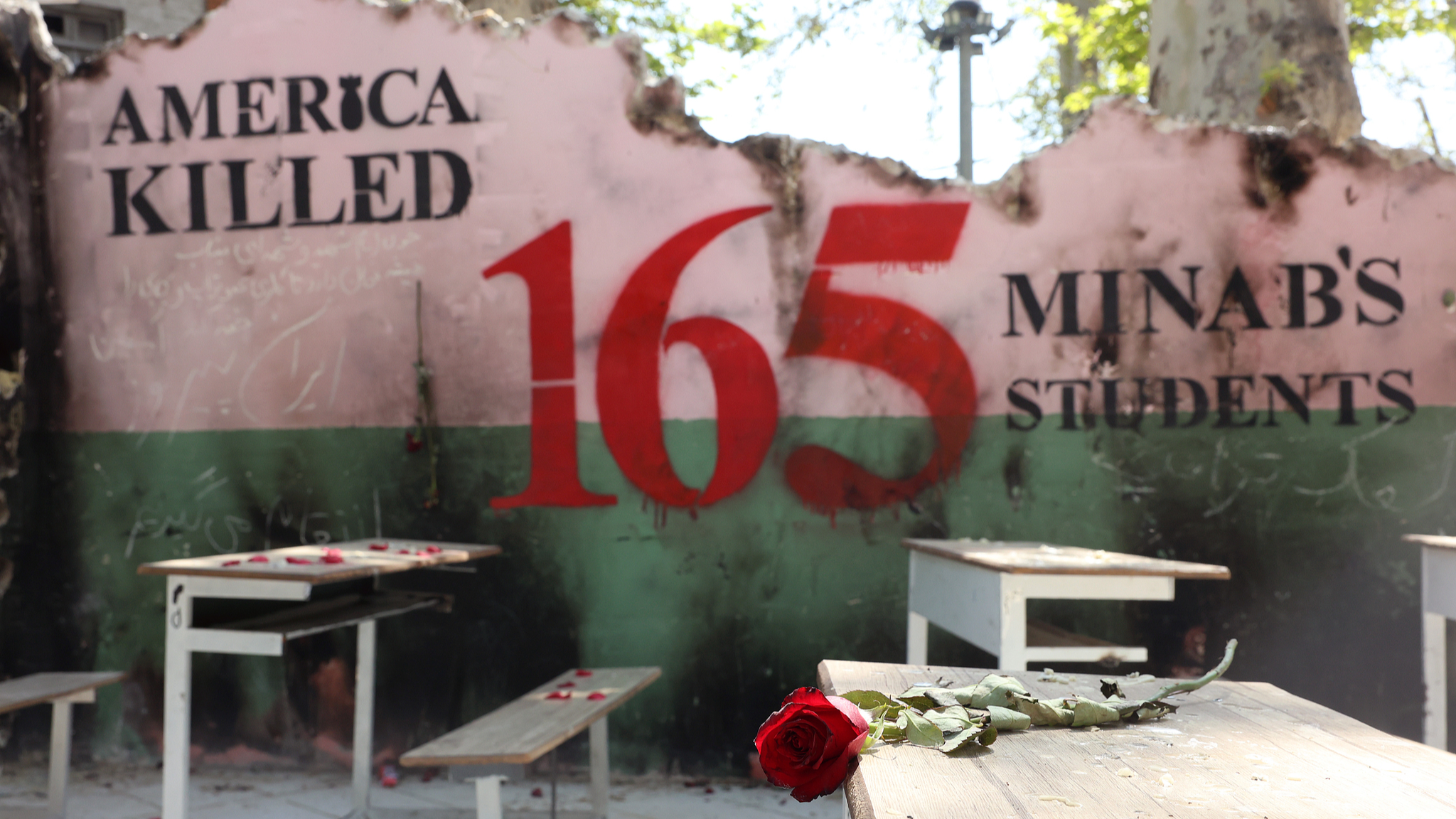 A flower is placed at a symbolic Minab school, referring to Minab School, which was targeted by a US air strike in which 165 schoolchildren and staff were killed, in northern Tehran, Iran, April 16, 2026. /VCG