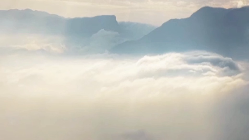 Golden sunlight streaming through a sea of clouds