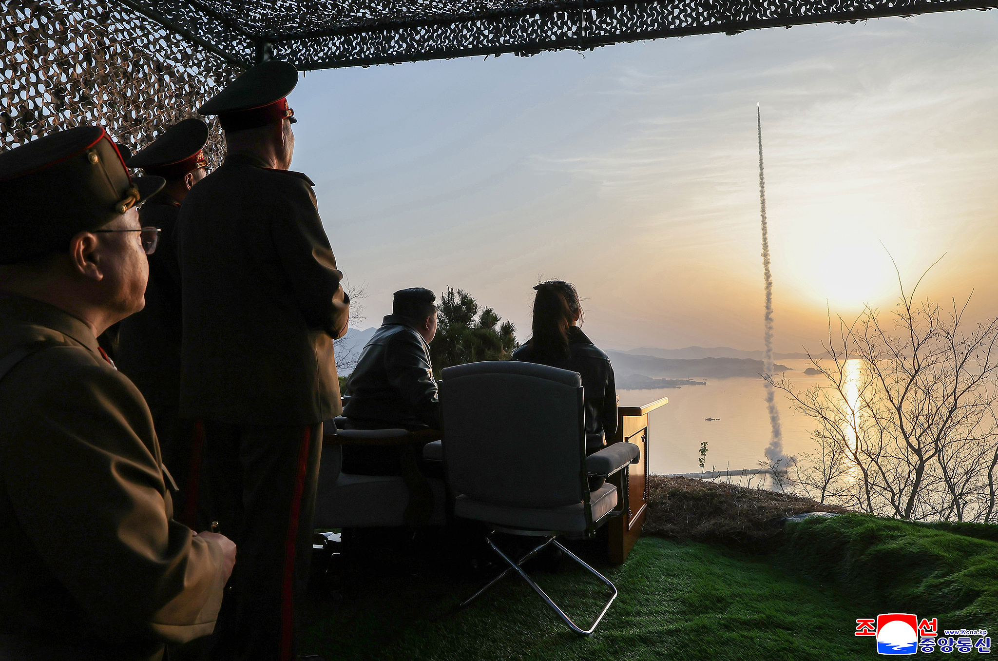 KCNA released a photo of DPRK leader Kim Jong Un (C) and his daughter, Kim Ju Ae (Centre R), observing the test-fire of an improved Hwasongpho-11 Ra surface-to-surface tactical ballistic missile at an undisclosed location in DPRK, April 19, 2026. /VCG