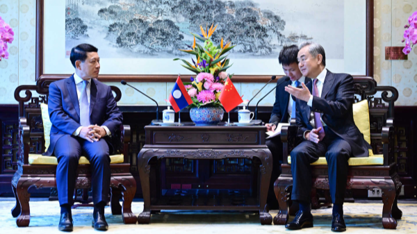 Chinese Foreign Minister Wang Yi (R), also a member of the Political Bureau of the Communist Party of China Central Committee, meets with Lao Deputy Prime Minister Saleumxay Kommasith, also a member of the Political Bureau of the Lao People's Revolutionary Party Central Committee, in Beijing, China, April 21, 2026. /Chinese Foreign Ministry