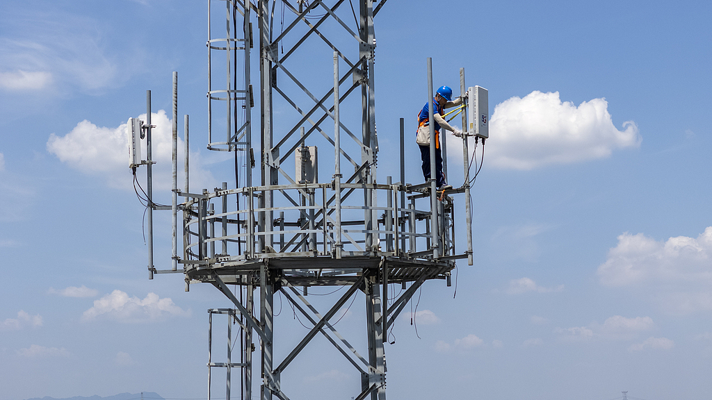 Engineers inspect and maintain 5G equipment on a communications tower in Jinhua City, east China's Zhejiang Province, July 5, 2025. /VCG