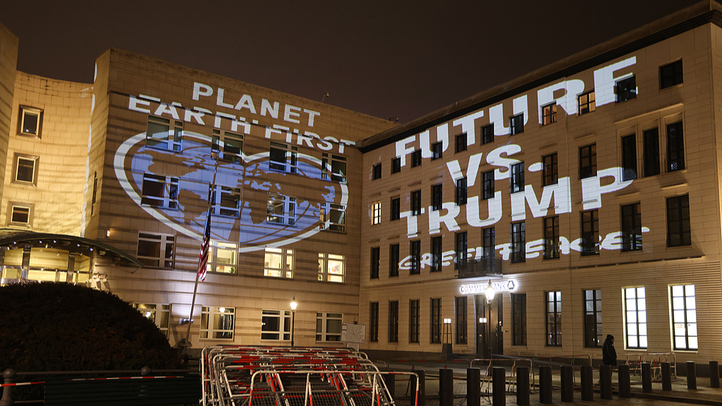Activists project an illumination that reads 
