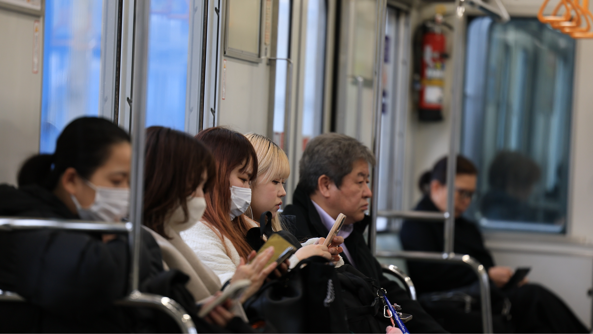 People check their mobile phones on the subway in Tokyo, Japan, March 14, 2025. /VCG