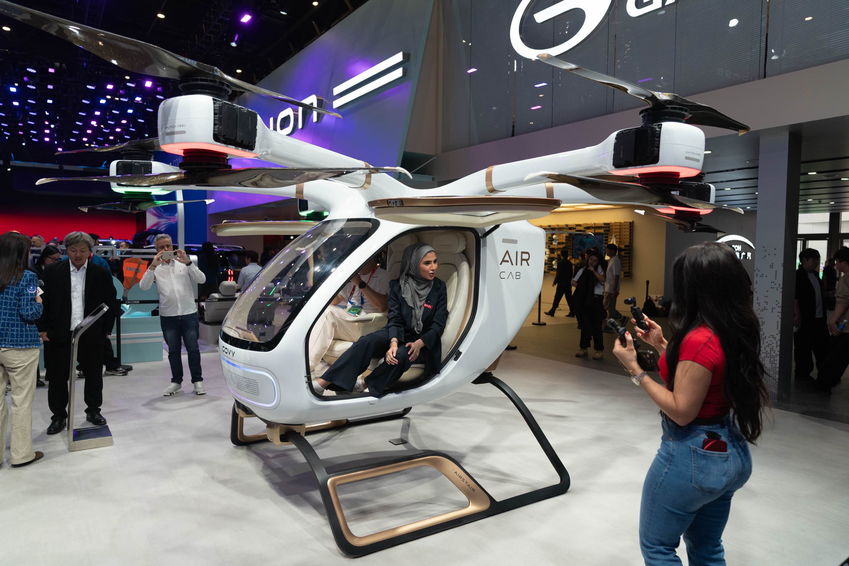 Media participants experience a composite-wing flying car at the 2026 Beijing Automotive Exhibition on April 24, 2026. /CGTN Photographer Qu Bo