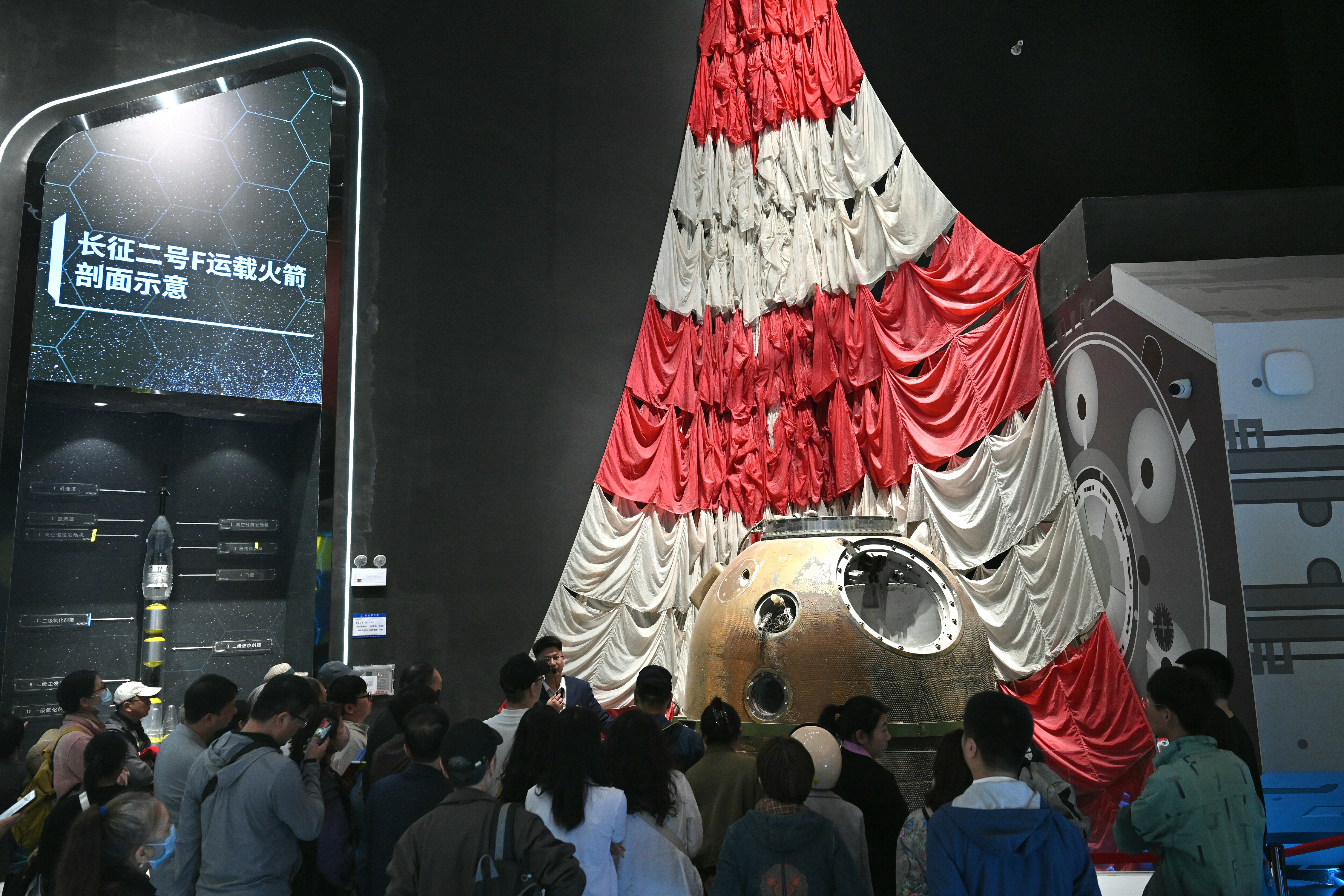 Visitors drawn to the actual Shenzhou IV return module displayed at the China Space Museum in Beijing, which offered free admission on the 11th China Space Day on April 24, 2026. /VCG