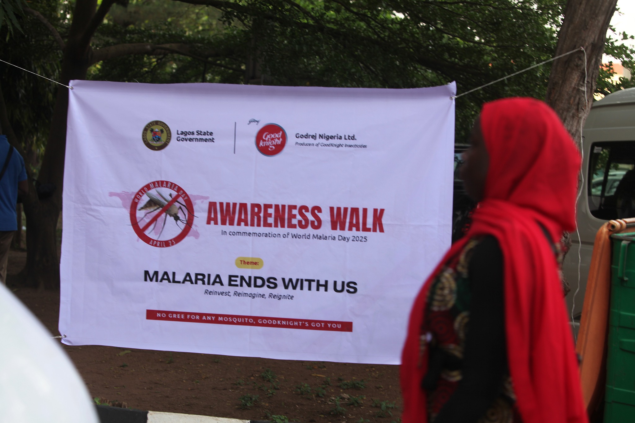 A woman walks past a banner during an awareness walk and stakeholder engagement event organized by the Lagos State Ministry of Health and its partners to mark World Malaria Day in Lagos, Nigeria, April 25, 2025. /VCG