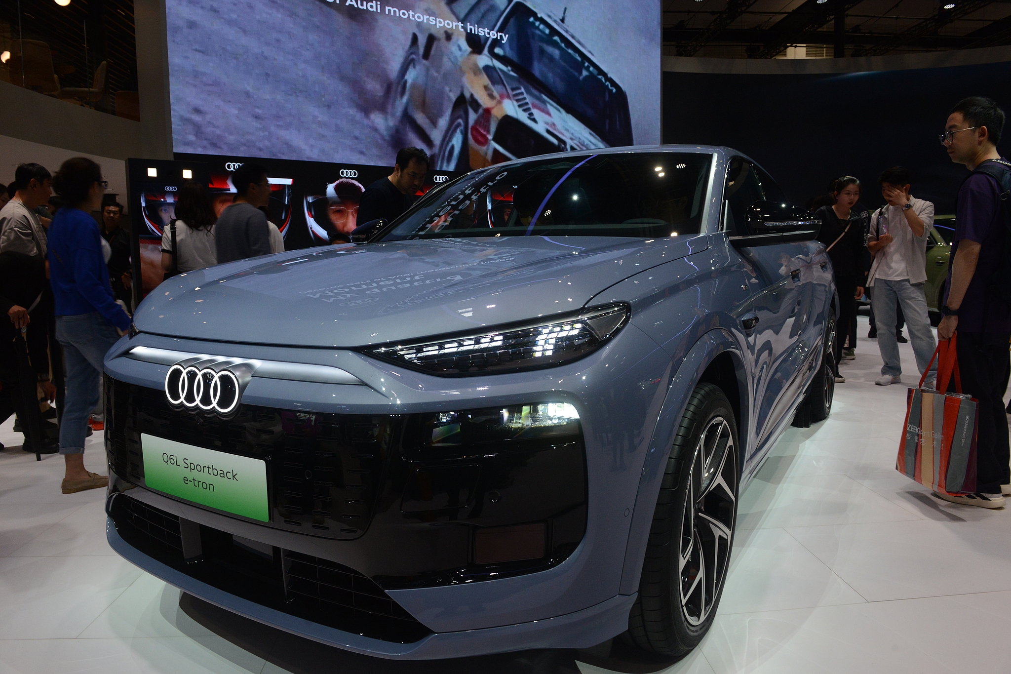 Visitors looking at an Audi Q6L car during the Beijing Auto Show 2026, where the booths of local brands and new energy vehicle manufacturers have become a huge focus, Beijing, China, April 26. 2026. /VCG