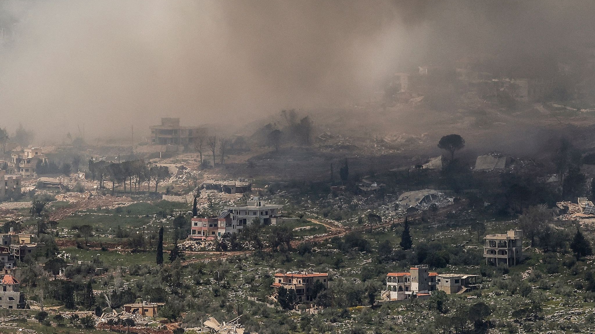 Smoke and dust engulf a town following Israeli explosions destroying buildings and homes in southern Lebanon near the border as seen from the Upper Galilee in northern Israel on April 27, 2026. /VCG