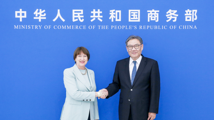 Chinese Commerce Minister Wang Wentao shakes hands with Hildegard Mueller, president of the German Association of the Automotive Industry, in Beijing, China, April 27, 2026. /Chinese Commerce Ministry