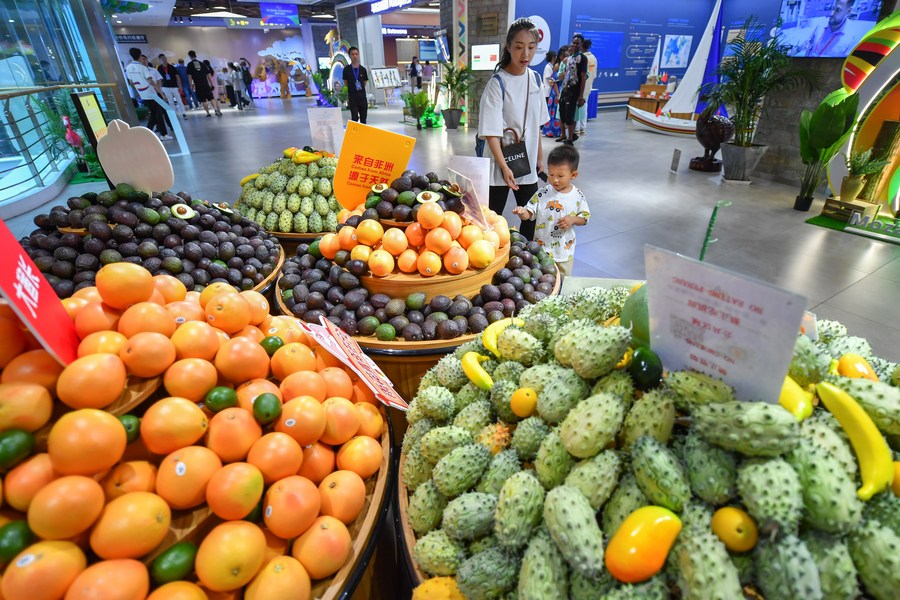 A woman and her child shop for African fruits at the China-Africa Economic and Trade Cooperation Promotion Innovation Demonstration Park in Changsha, central China's Hunan Province, July 1, 2023. /Xinhua