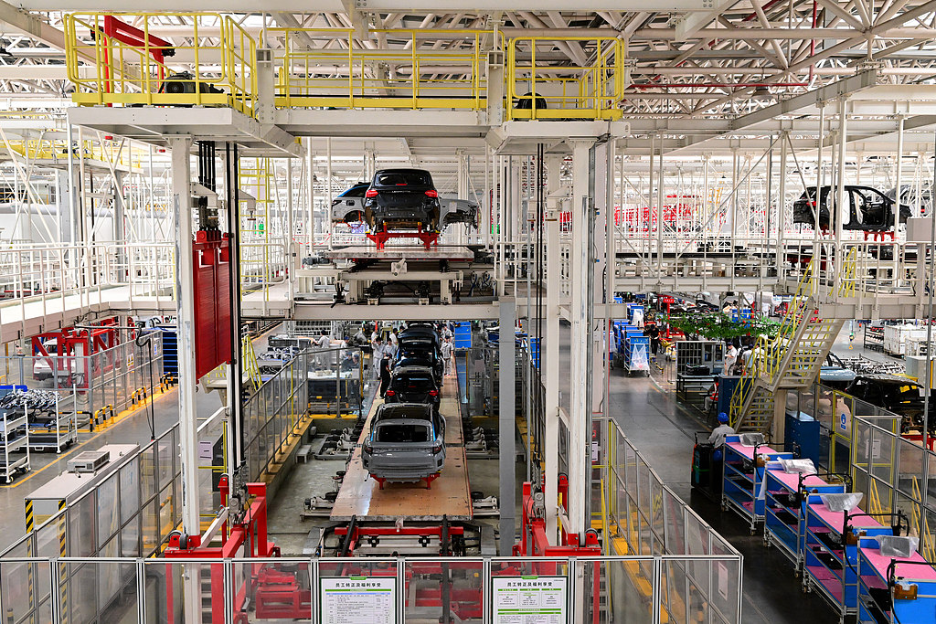 Workers assemble components at a smart factory in Jinhua, Zhejiang Province, May 13, 2025. /VCG