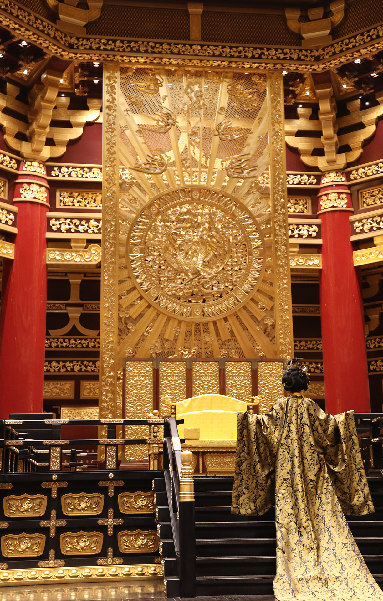 A visitor dressed up as Wu Zetian poses for photos at Mingtang in Luoyang, Henan Province. /CGTN