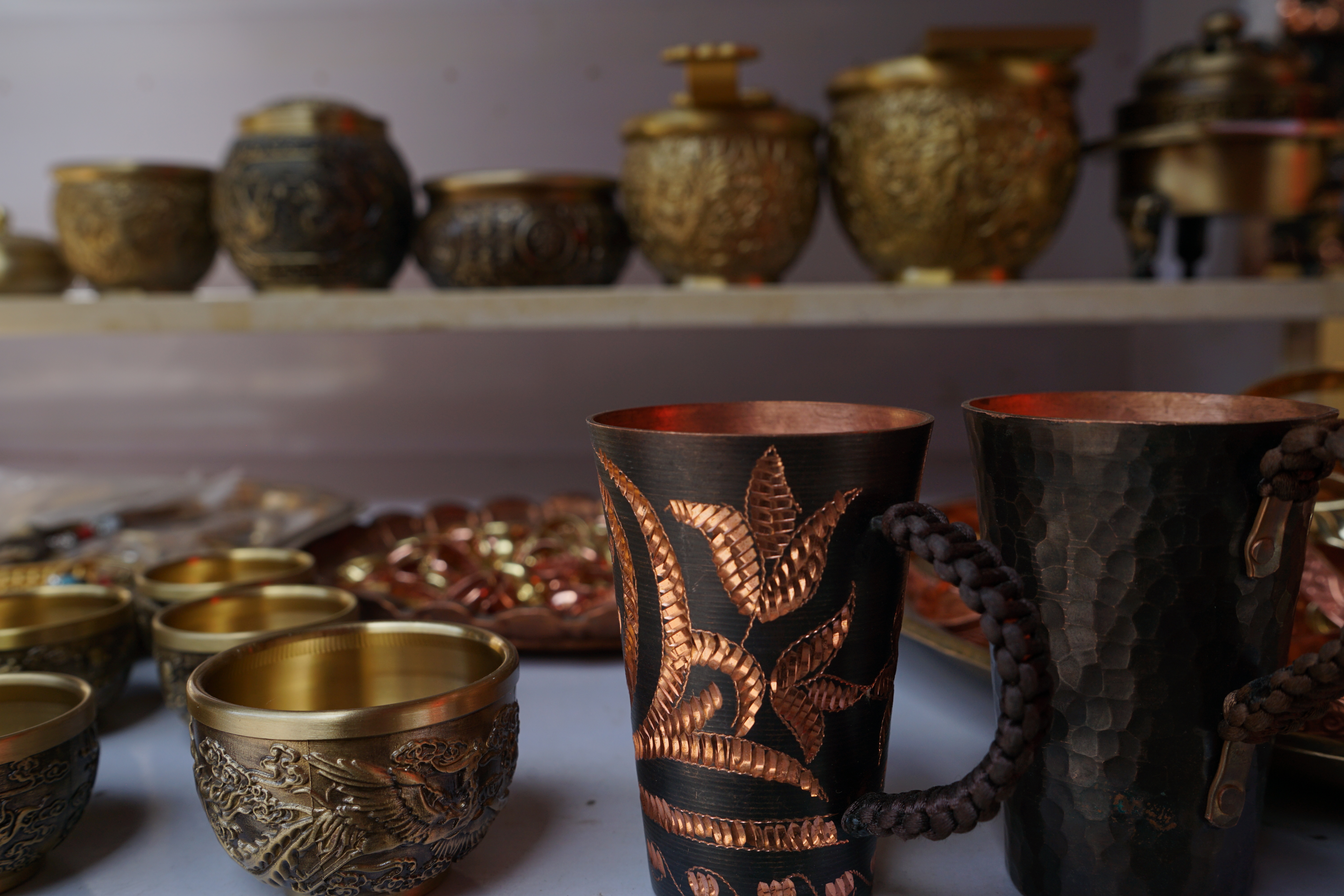 Copperworks are seen on the shelves of a shop in Kashi, China's Xinjiang. /CGTN