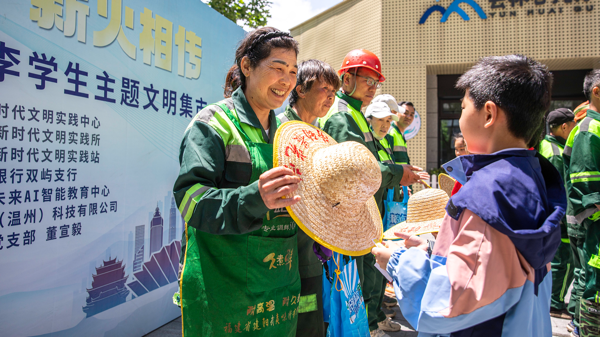 Students present cooling gift packages to sanitation workers to pay tribute to them ahead of the International Workers' Day in Wenzhou, east China's Zhejiang Province, April 30, 2026. /VCG