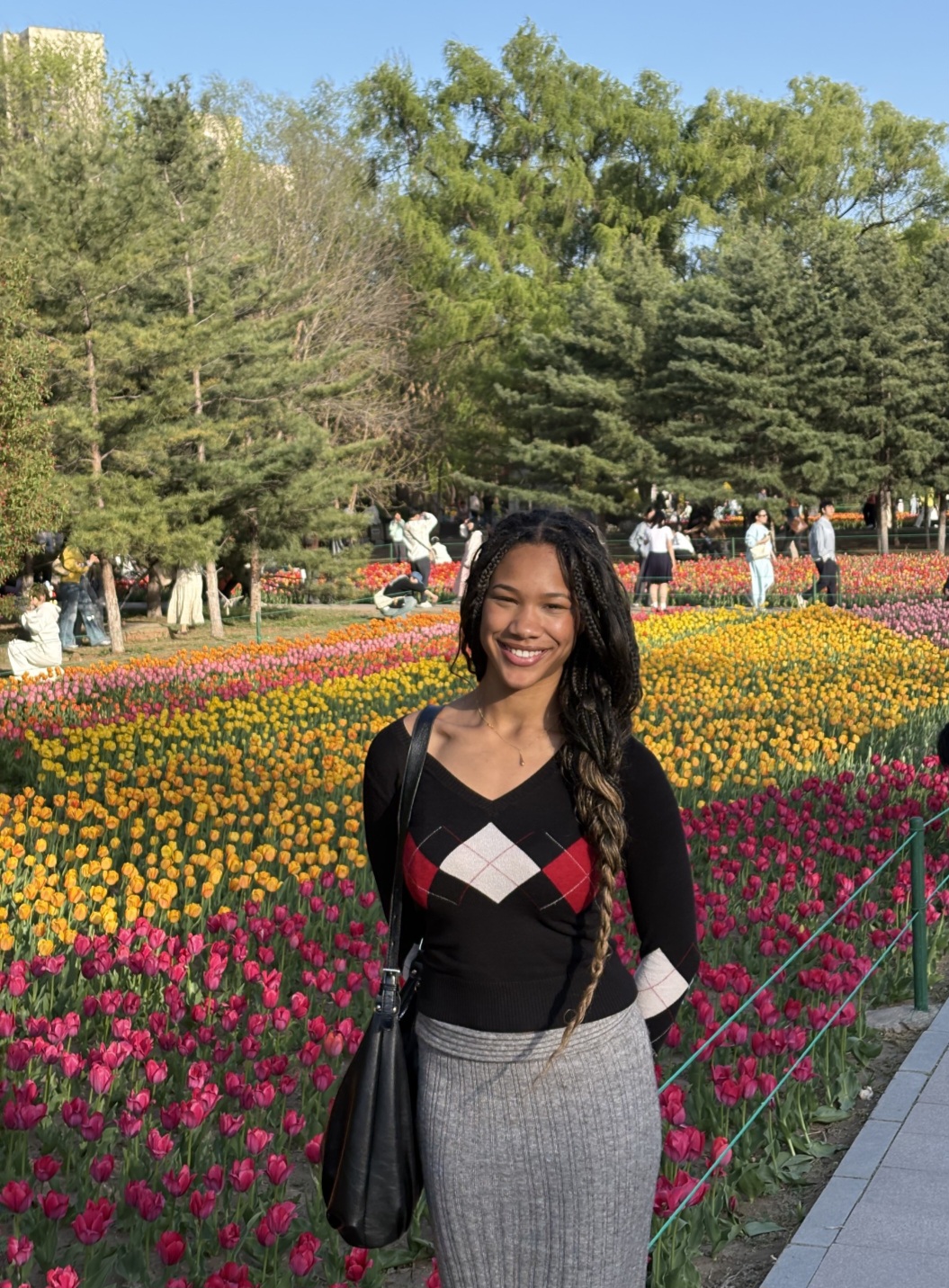 Jennifer strikes a pose in front of brightly-colored tulips at a park she discovered in Shenyang, Liaoning Province. /Jennifer Karin Pelu Fortes