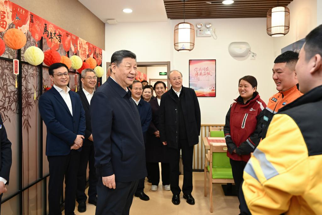 Chinese President Xi Jinping, also general secretary of the Communist Party of China Central Committee and chairman of the Central Military Commission, talks with delivery workers while visiting a community canteen for seniors in Xicheng District of Beijing, capital of China, February 10, 2026. /Xinhua