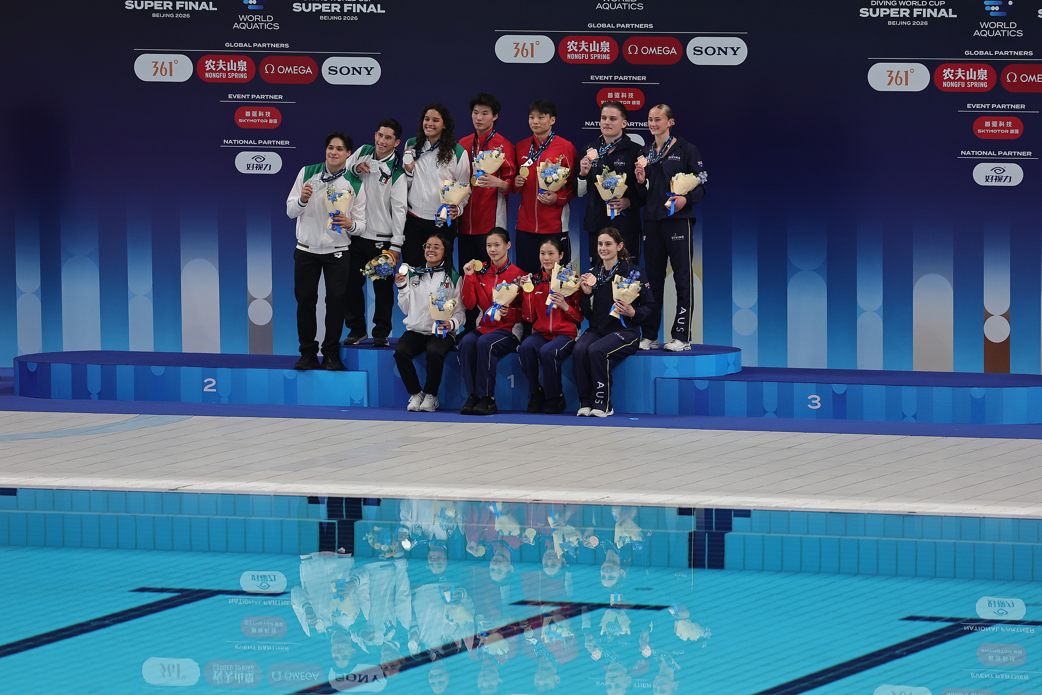 Chinese Team Bai Yuming, Liu Chengzhan, Lu Wei, and Lin Shan during the mixed team final on the podium at the 2026 World Aquatics Diving World Cup Super Final in Beijing, China, May 1, 2026. /VCG