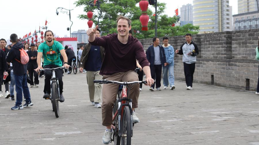 Foreign tourists ride bicycles on top of the city wall in Xi'an, Shaanxi Province in northwest China during the May Day holiday, May 2, 2026. /Xinhua