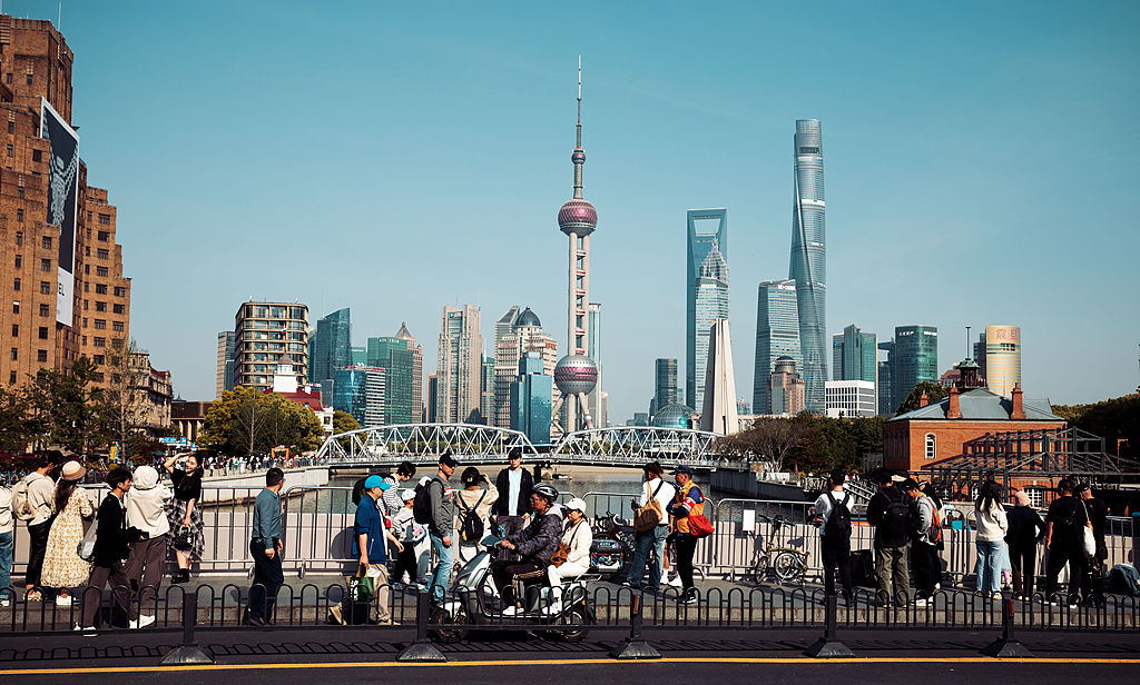 People cross a bridge on the Bund amid Labour Day celebrations in Shanghai, China, May 1, 2026. /VCG