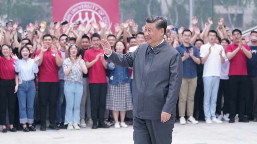 President Xi Jinping, also general secretary of the Communist Party of China Central Committee and chairman of the Central Military Commission, waves to teachers and students during a visit to Renmin University of China in Beijing, April 25, 2022. /Xinhua