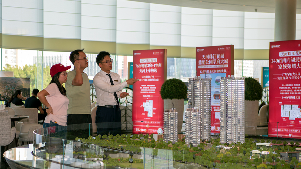 A sales staff presents a residential development to potential buyers in Guangzhou, Guangdong Province, April 25, 2026. /VCG