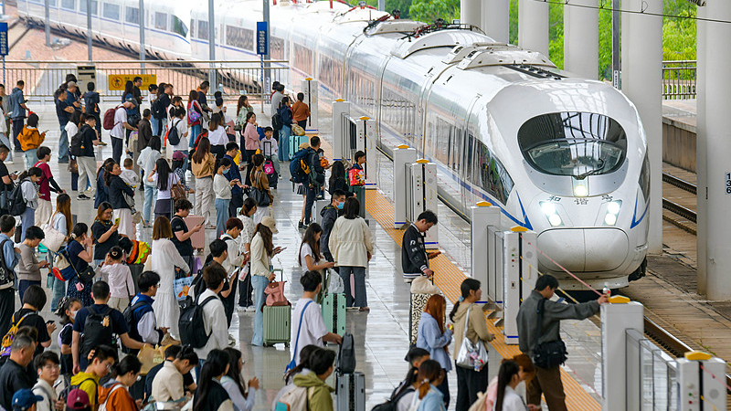 Passengers board a high-speed train at Longmen Station in Luoyang, Henan Province, central China, May 1, 2026. /VCG